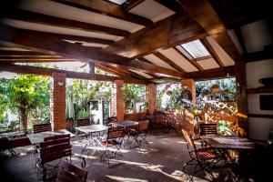 a patio with tables and chairs in a building at Casa Thomas Bran in Bran