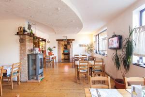 a restaurant with tables and chairs and a fireplace at Casa Thomas Bran in Bran