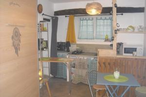a small kitchen with a table and a counter top at L'olivade Lou mas li pitchoun in Gordes