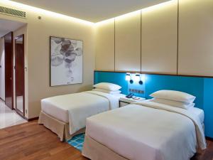 Hyatt Regency Thrissur客房内的一张或多张床位