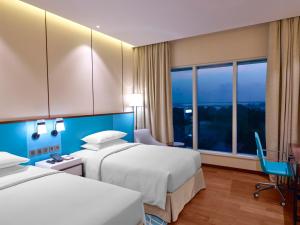 Hyatt Regency Thrissur客房内的一张或多张床位