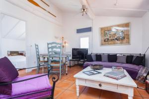 a living room with purple couches and a table at Appartements Vieux Nice / Marché aux fleurs in Nice