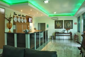a large room with a bar in the middle at Hotel Flor de Minas in Uberaba