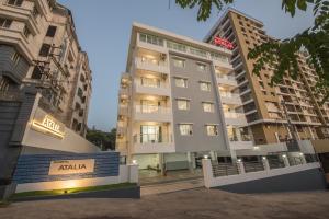 an apartment building with a sign in front of it at Manipal Atalia Service Apartments in Manipal