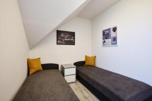 A bed or beds in a room at Óvár Apartman
