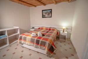 Łóżko lub łóżka w pokoju w obiekcie Hotel Puerto Inka
