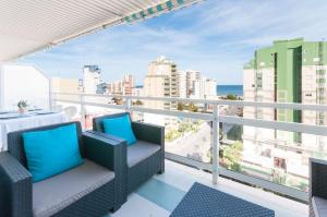 a balcony with chairs and a view of the ocean at AG FLORIDA in Playa de Gandia