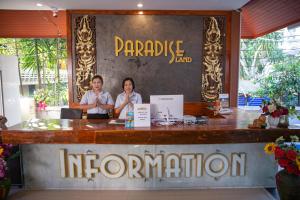 two people sitting at a bar in a restaurant at Paradise Land Resort in Pattaya North