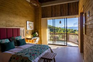 a bedroom with a large bed and a large window at Cannua Lodge in Marinilla