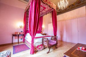 a bedroom with a canopy bed with pink curtains at B&B Galileo 2000 in Florence