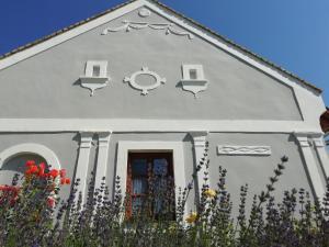 a white church with flowers in front of it at Arácsi Vendégház in Balatonfüred