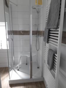 a glass shower with a stool in a bathroom at Stefanie in Heide
