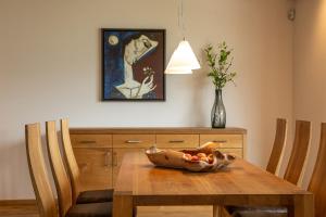 a dining room table with a bowl of fruit on it at Romantik Chalet im Weingut Eichenstein in Merano