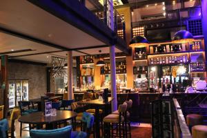 a restaurant with tables and chairs and a bar at The Lord Street Hotel; BW Signature Collection in Southport