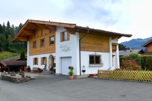 ein großes weißes Haus mit Holzdach in der Unterkunft Marie Luise, Landhaus in Reith bei Kitzbühel