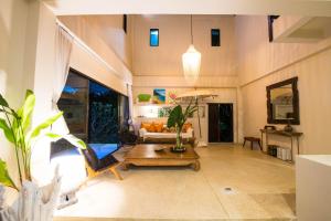 a living room with a couch and a table at Teak Hill Pool Villa-Rosewood in Ko Chang