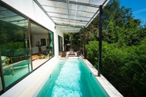 an indoor swimming pool in a house at Teak Hill Pool Villa-Rosewood in Ko Chang
