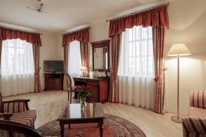 a living room with a couch and a table at National Hotel in Klaipėda