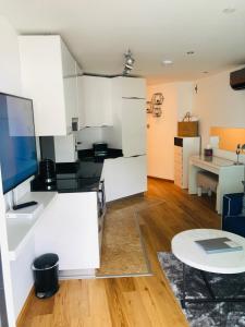 a kitchen with a stove a refrigerator and a microwave at Luxe Holiday Rentals in Gibraltar