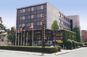 un bâtiment avec deux drapeaux devant lui dans l'établissement Hotel Leopardi, à Vérone