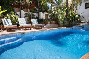 a swimming pool with chairs and a swimming pool at PAL.MAR Hotel Tropical in San Francisco