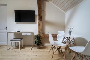 ein Wohnzimmer mit einem Tisch und Stühlen sowie einem TV in der Unterkunft HOTEL N°10 in Lwiw