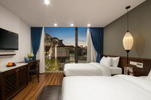 Voodi või voodid majutusasutuse Hanoi Exclusive Hotel toas