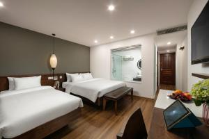 Voodi või voodid majutusasutuse Hanoi Exclusive Hotel toas