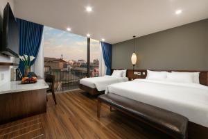 Voodi või voodid majutusasutuse Hanoi Exclusive Hotel toas