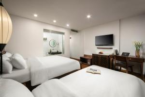 Voodi või voodid majutusasutuse Hanoi Exclusive Hotel toas