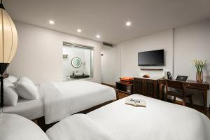 Voodi või voodid majutusasutuse Hanoi Exclusive Hotel toas