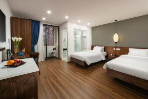 Voodi või voodid majutusasutuse Hanoi Exclusive Hotel toas