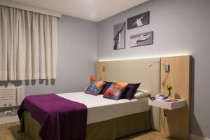 Postel nebo postele na pokoji v ubytování Rio Hotel by Bourbon Curitiba