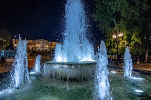 a water fountain in a city at night at Triple A - Graffiti Homage in Psirri Square - FREE Parking! in Athens