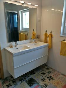 a bathroom with a sink and a large mirror at Sea and Wind Villa Labin in Labin