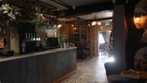 a bar in a restaurant with a counter and chairs at The Station Restaurant & Bar in Doncaster