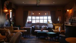a restaurant with couches and tables and a window at The Station Restaurant & Bar in Doncaster