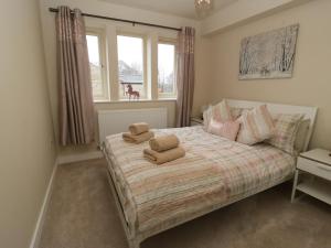 a bedroom with a bed with two towels on it at Modern Town House Shepley in Huddersfield