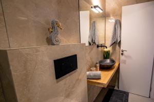 a bathroom with a seahorse statue on a wall at Triple A - Graffiti Homage in Psirri Square - FREE Parking! in Athens