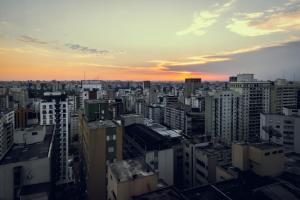 a view of a city skyline at sunset at Royal Jardins Boutique Hotel in São Paulo