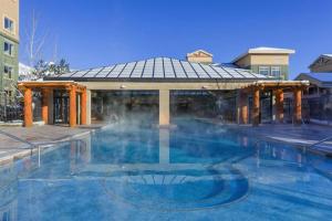 a heated pool with a gazebo with steam coming out at 4.5 Star!~Come to Paradise~Utah Alps~back door ski in Park City