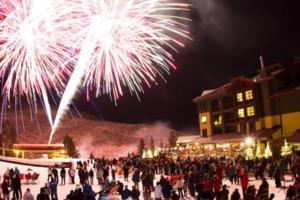 a crowd of people standing in the snow watching fireworks at 4.5 Star!~Come to Paradise~Utah Alps~back door ski in Park City