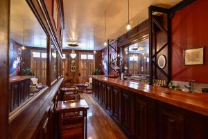 a bar with wooden tables and chairs in a room at Casa California Guesthouse in Valparaíso
