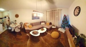a living room with a christmas tree and a couch at Vikend Kuća Iman in Vlasic