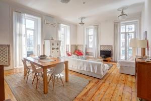 a living room with a table and a couch at Lisbon Tejo Apartment Best Location with River View in Lisbon