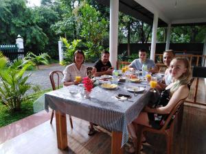 a group of people sitting around a table at Jungle View Guest in Polonnaruwa