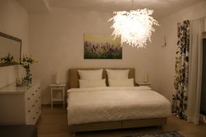 a bedroom with a bed and a chandelier at Penthouse Wäschenbeuren in Wäschenbeuren