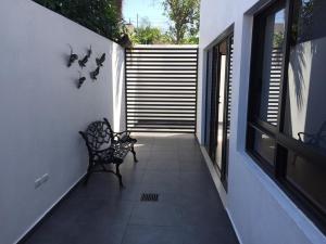 a bench sitting on the side of a house at Apartamentos Torre II Condominios - Pet Friendly in Mazatlán