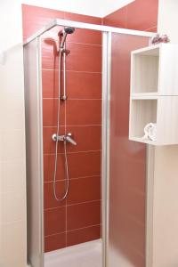 a shower with a glass door in a bathroom at B&B La Graticola Ristorante Pizzeria in Trepuzzi