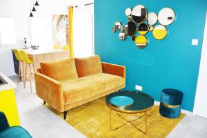 a living room with a couch and a table at Logis Hôtel La Chaize in Noirmoutier-en-l'lle
